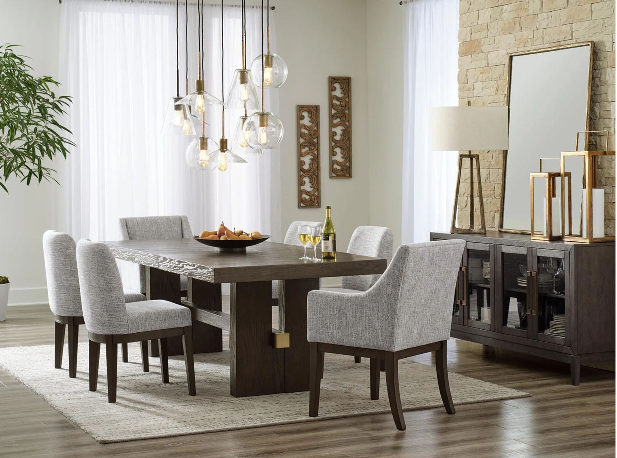Modern dining room with a table, chairs, mirror, and decorative lighting.