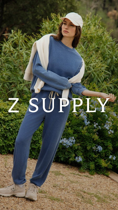 Woman in casual blue outfit with white cap, standing outdoors. Z Supply logo visible.
