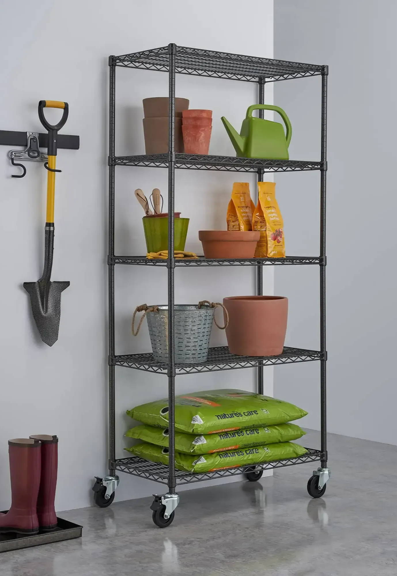 black wire shelving rack in a garage filled with gardening supplies