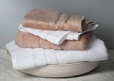 stack of tan and white bamboo hand towels