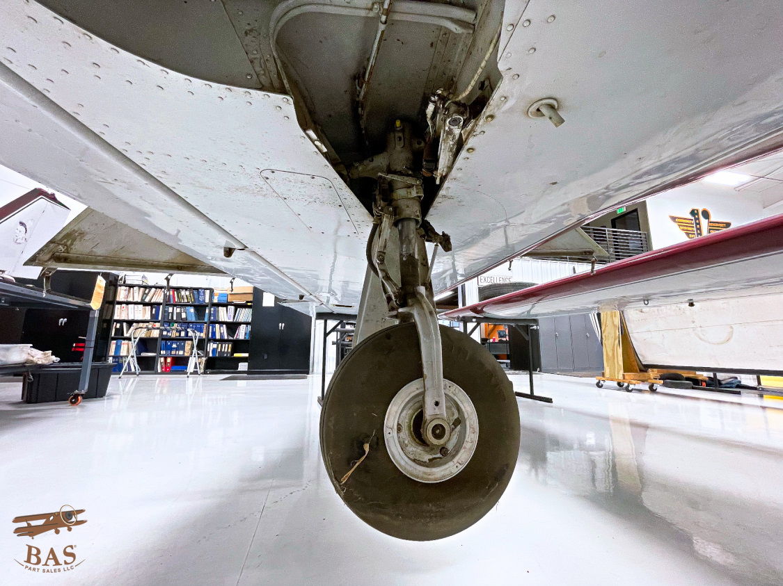 Close-up of an aircraft landing gear in a hangar.