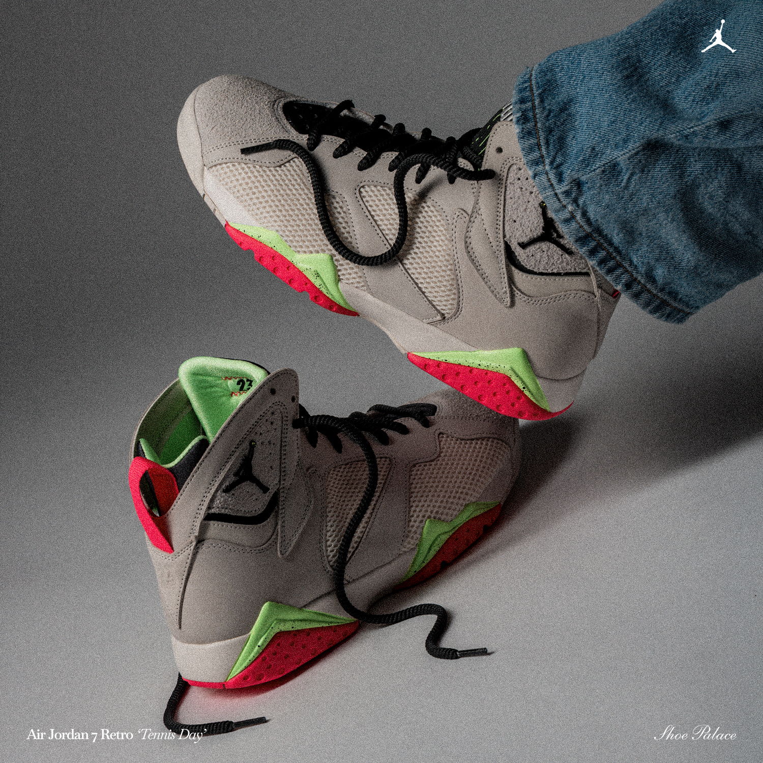 A pair of gray Nike sneakers with green and red accents.