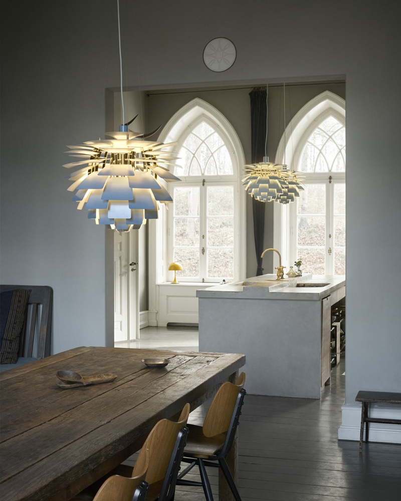 Modern pendant light with layered, leaf-like design in white.