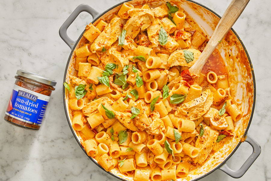 Rigatoni pasta in a creamy tomato and cheese sauce with chicken prepared in a pot