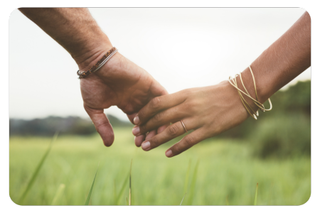 coping with fertility loss after cancer and menopause hand holding walking through a field 