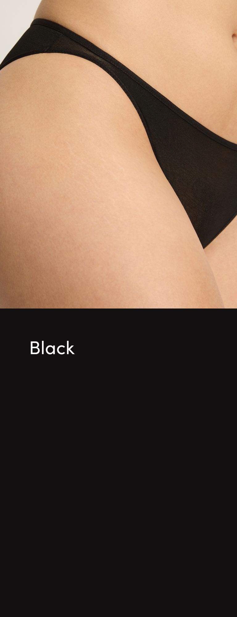 Close-up of skin wearing black underwear against a dark background.