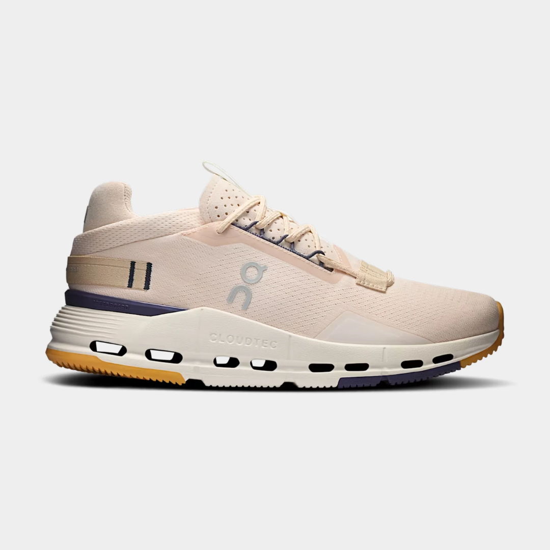 Light pink athletic shoe with a white sole and purple accents.