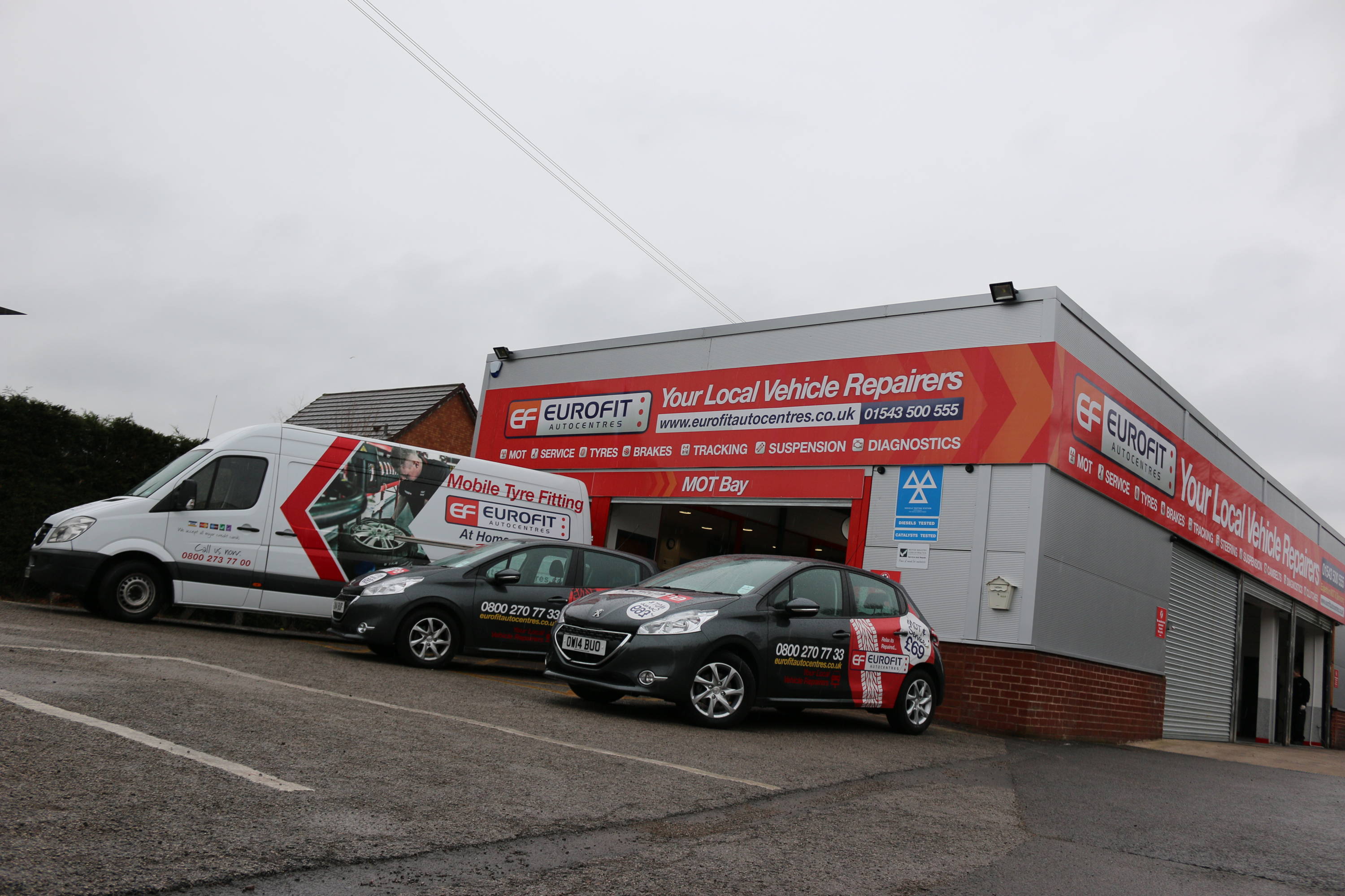 Outside Eurofit Cannock car garage with cars and vans parked outside with logo on
