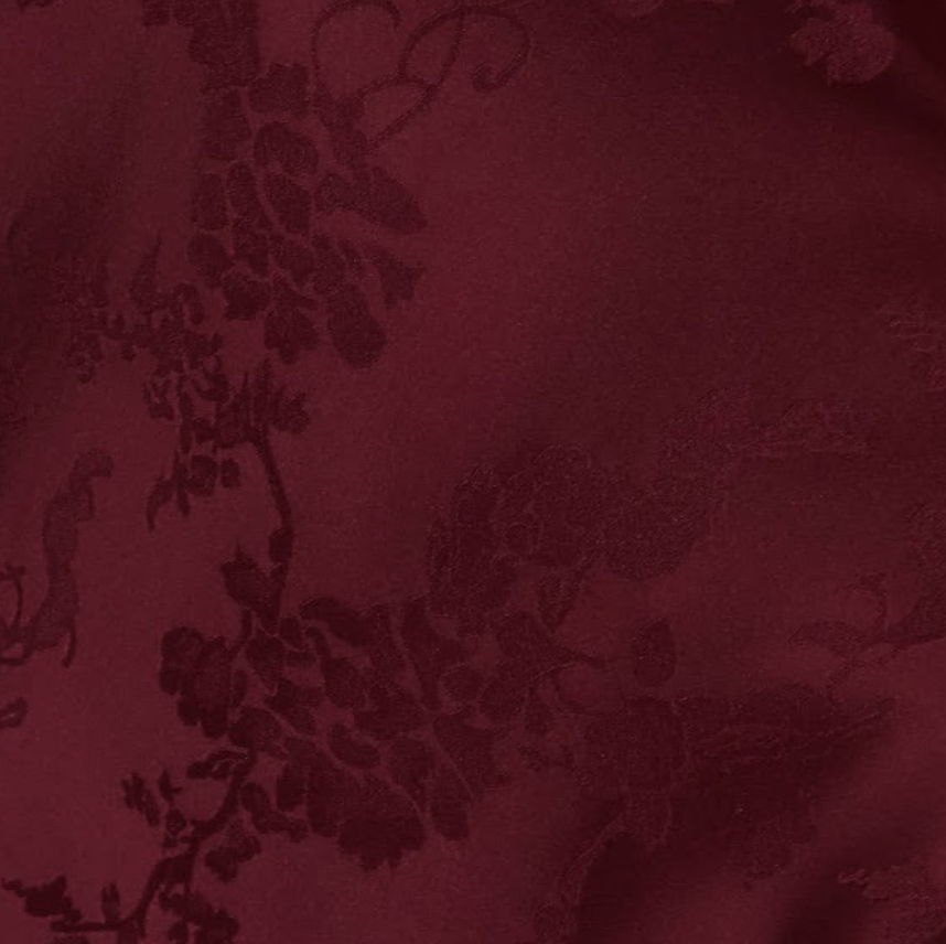 Burgundy fabric with floral pattern texture.