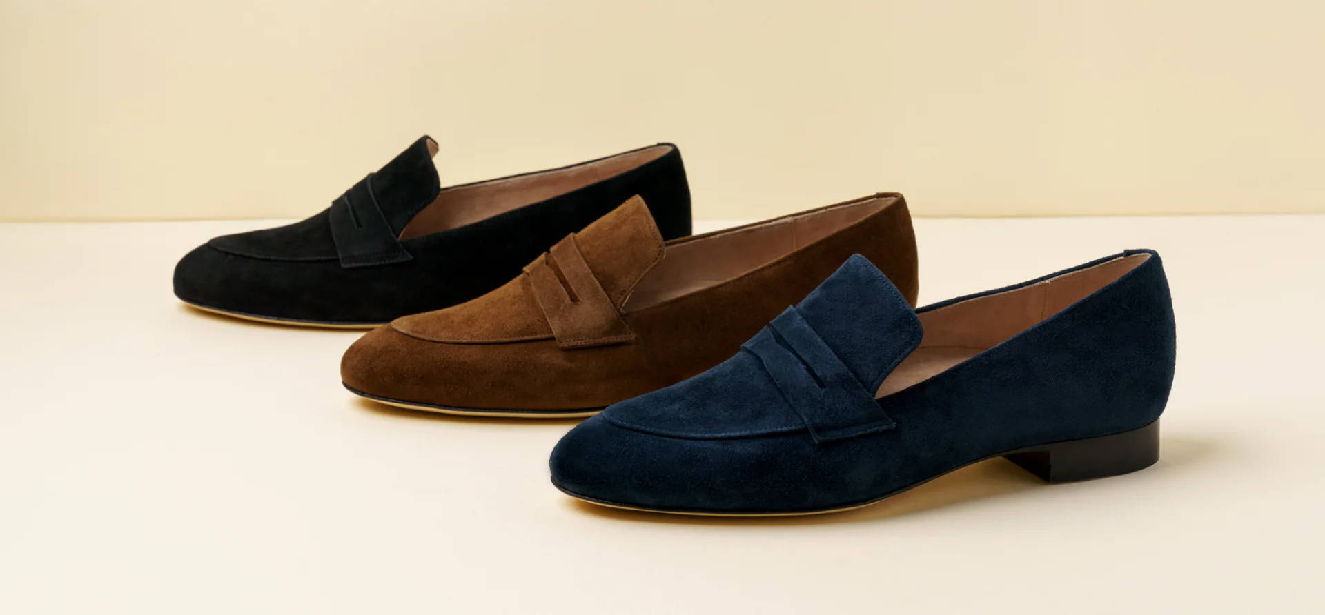 Three pairs of loafers in black, brown, and navy blue.