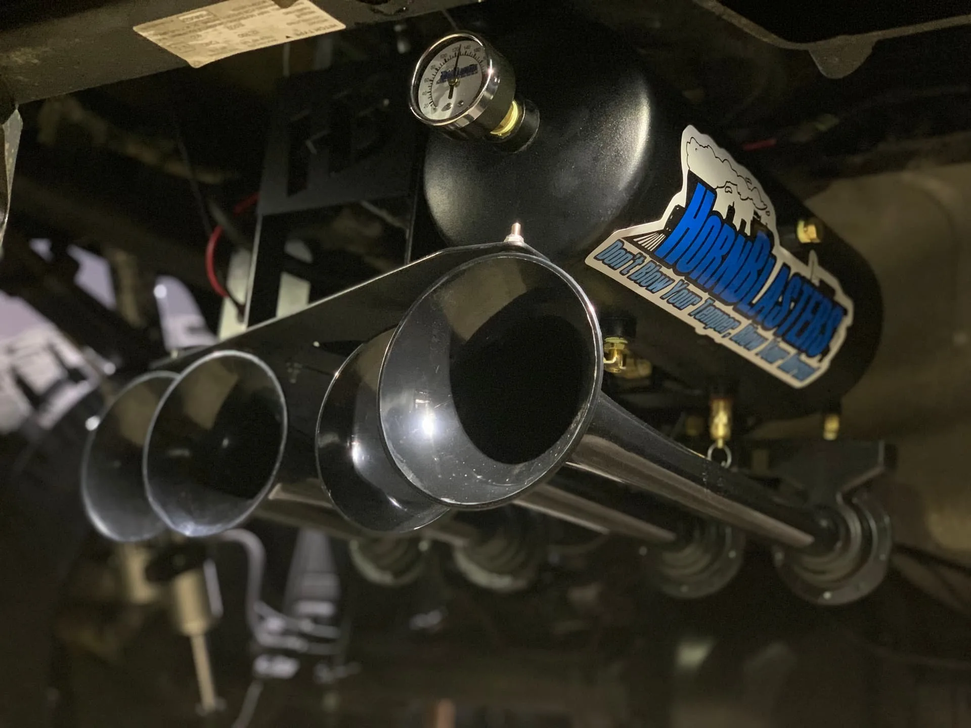 Black HornBlasters train horns and air tank mounted under truck