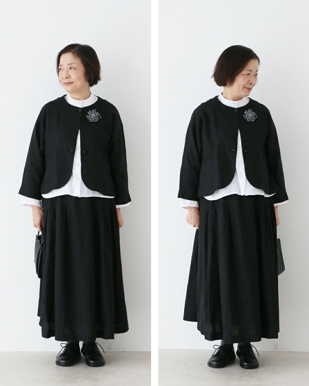 Woman in black outfit standing against a white background.