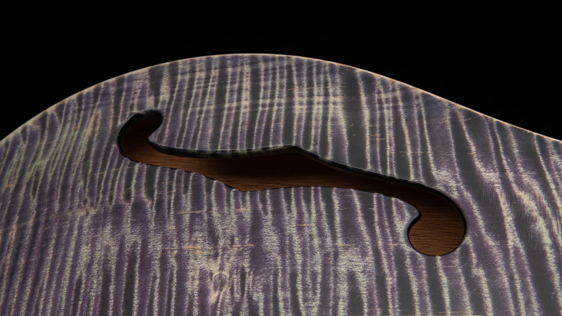 Close-up of a PRS wooden guitar body with a sound hole.