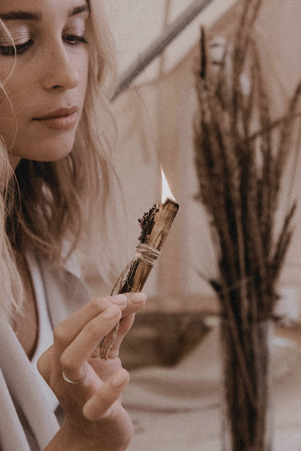 a woman with burning palo santo st soleil