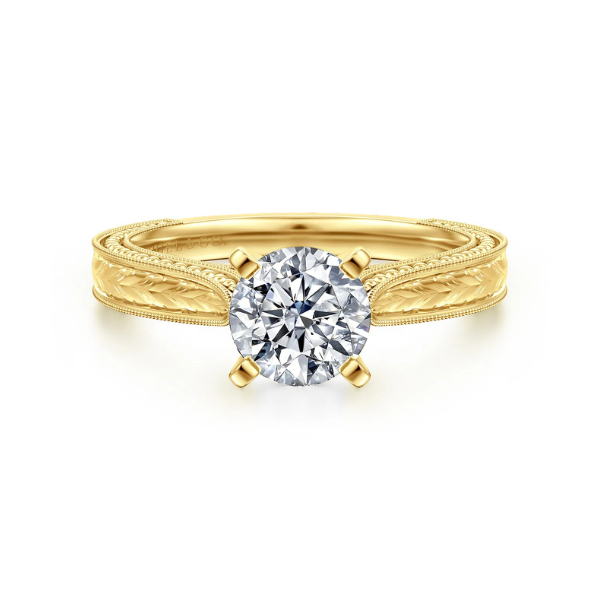 Gold ring with a round diamond centerpiece.