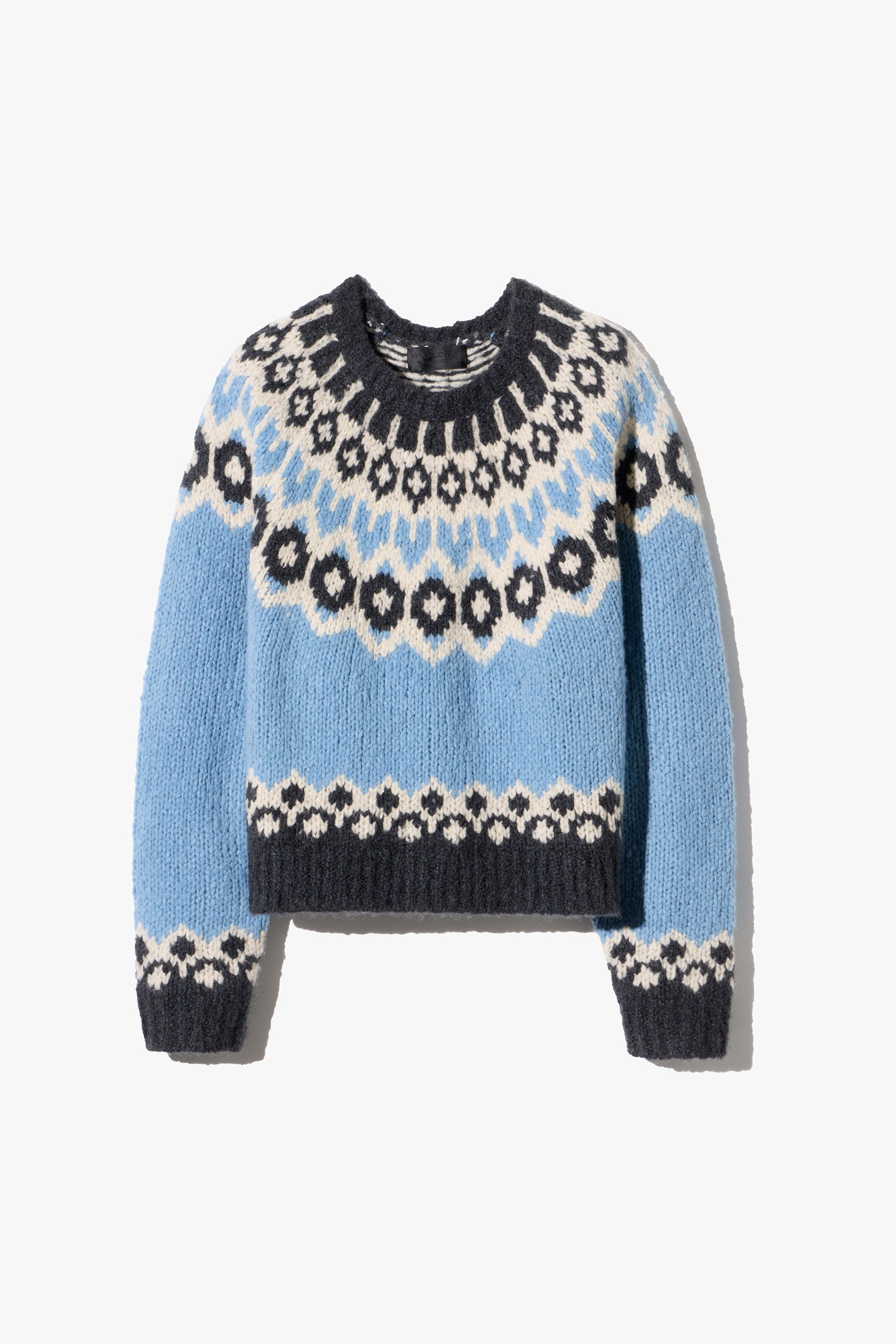 Light blue sweater with black and white geometric patterns.