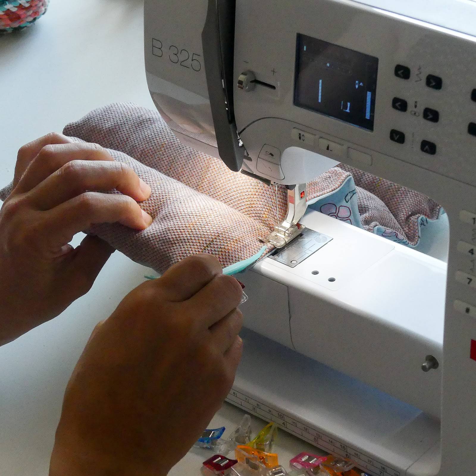 using a sewing stiletto to keep the edge closed under the sewing machine