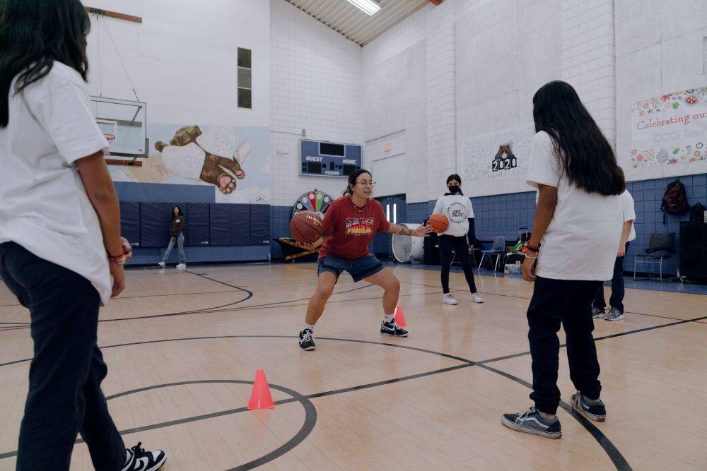 girl practicing dribbling 2 balls