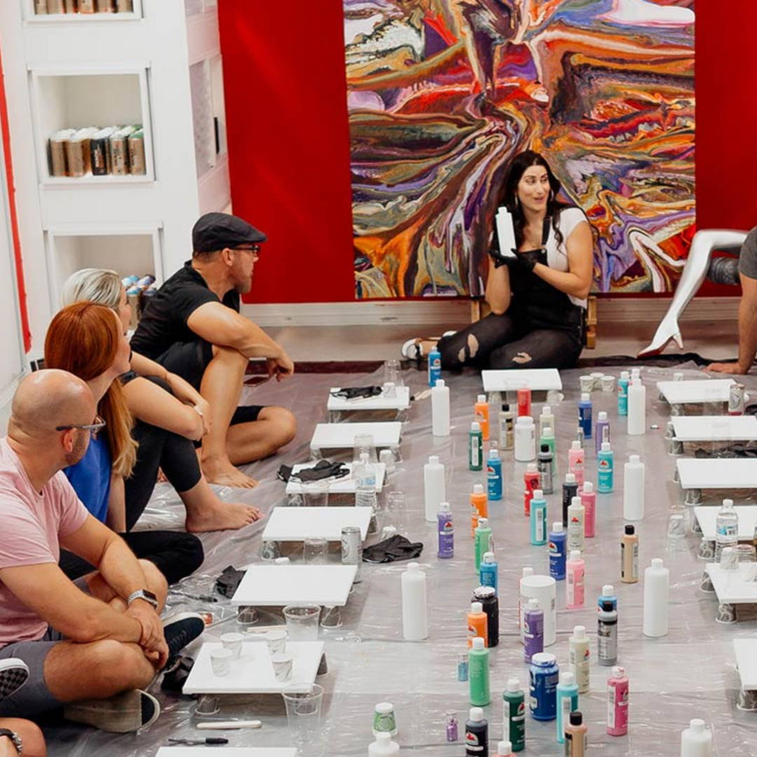 resin artist Leila Parnian teaching a dirty pour art class to fellow resin artists