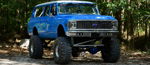 Blue lifted classic Suburban front three-quarter thumbnail