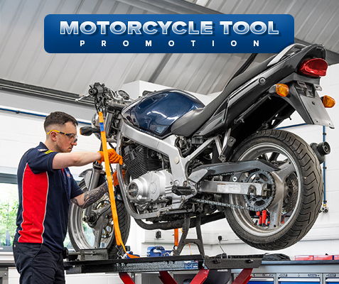 Person working on a motorcycle in a shop, promoting motorcycle tools.
