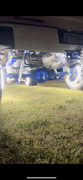 Rear undercarriage showing Outlaw train horns and blue suspension under Ethan's 2014 Chevrolet Silverado 1500 photo 4
