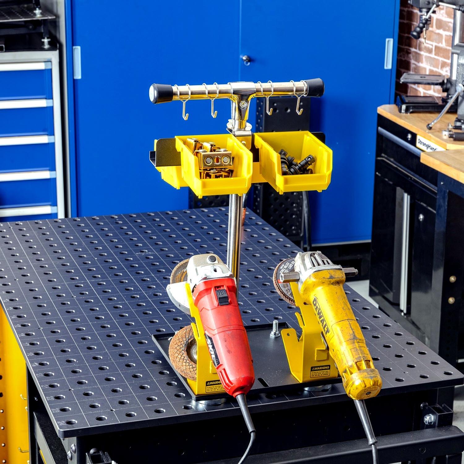 Two power tools on a workbench with storage bins in the background.