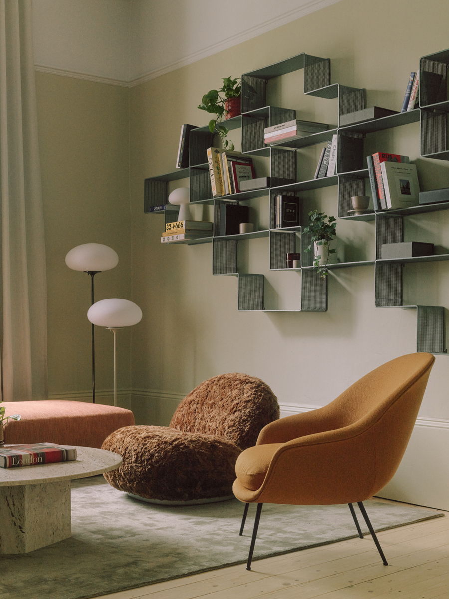 Modern living room with unique shelves and stylish furniture.