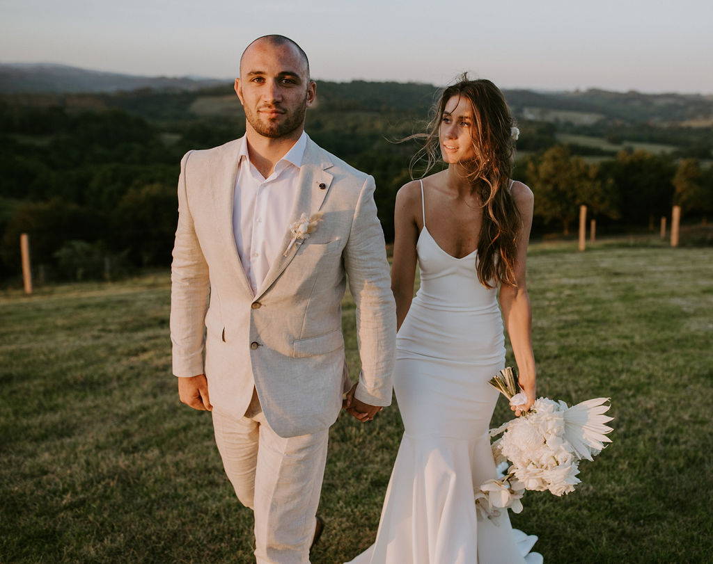 Grace Loves Lace bride wearing the Clo Crepe wedding dress and groom in a beige suit