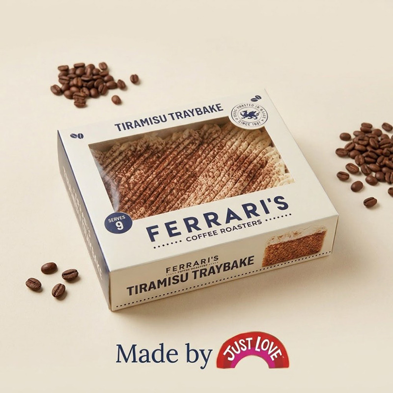 Ferraris Coffee Tiramisu Traybake made by Just Love Food Company, shown in branded packaging surrounded by roasted coffee beans.