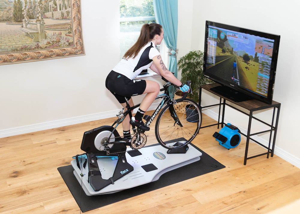 Woman cyclist riding on the Velocity Rocker while using Zwift.