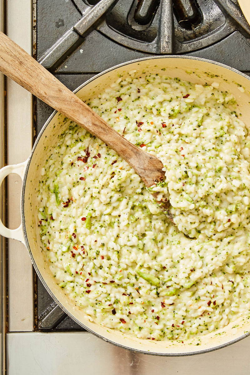 Broccoli and cheese risotto in a sauce pan