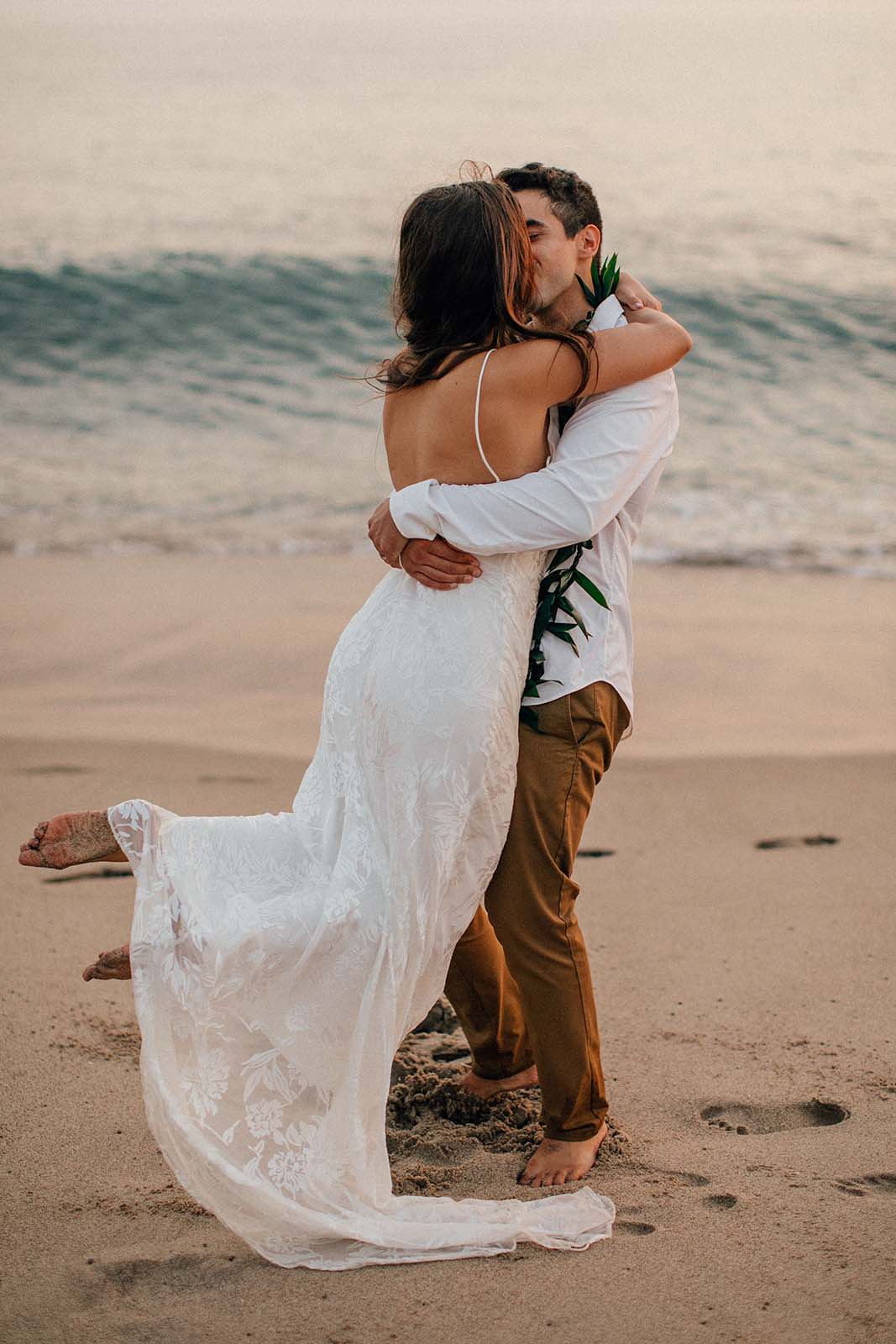 Bride and groom, sharing a romantic kiss on the beach