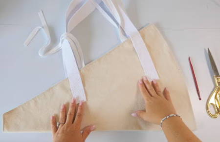 A finished flower bag with two handles and ties, outside view