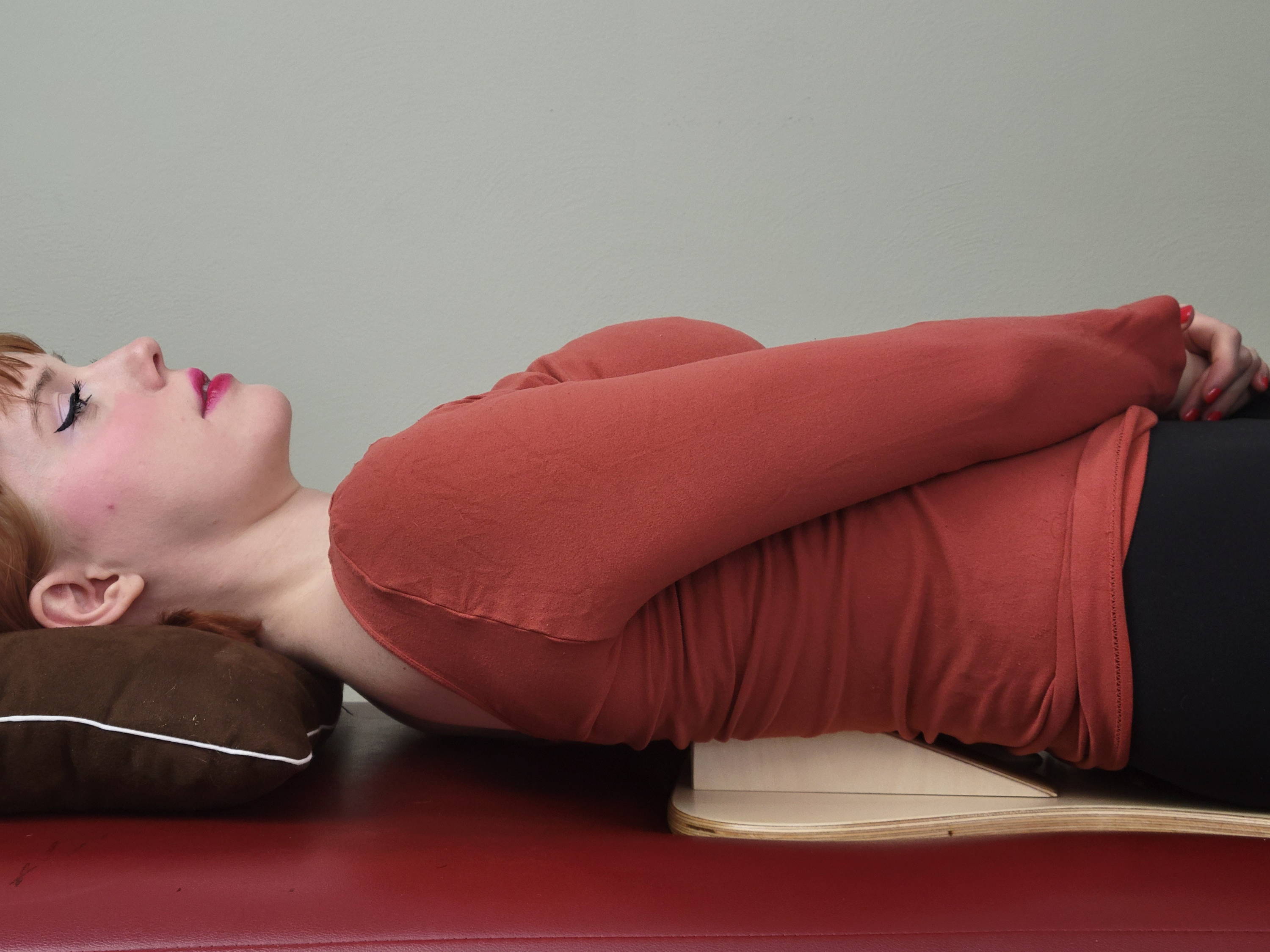woman laying on PurePosture board lumbar