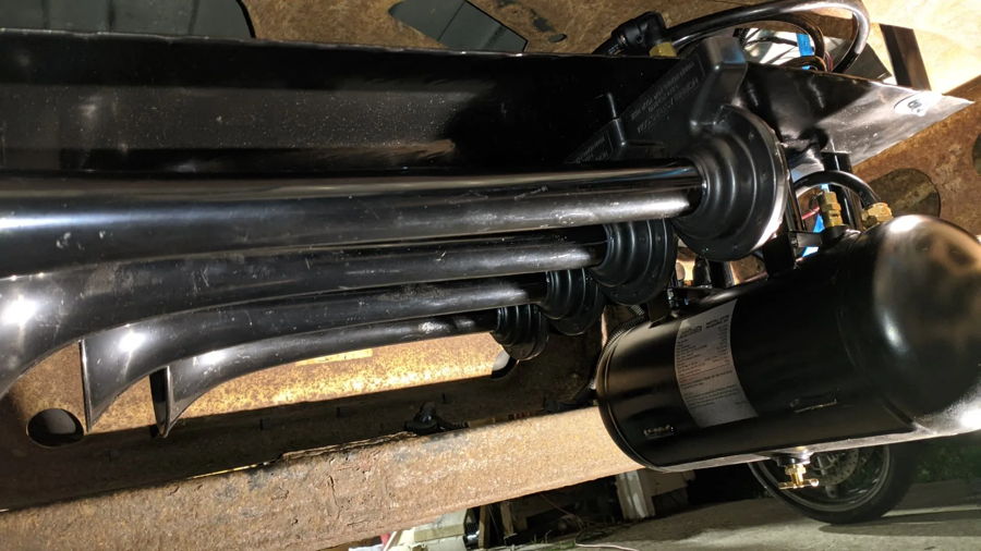 Four black train horns horizontal air tank rusty frame rails wheel well brass fittings Pat's GMC Savana 127H gallery photo 3