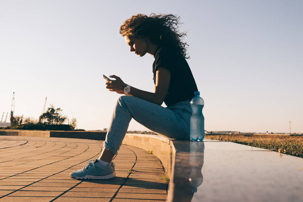 Athlete updates her water reminder app after a workout.