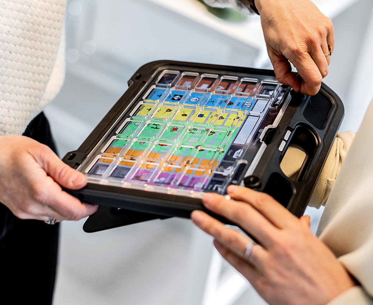 Woman attaching keyguard to a communication device 