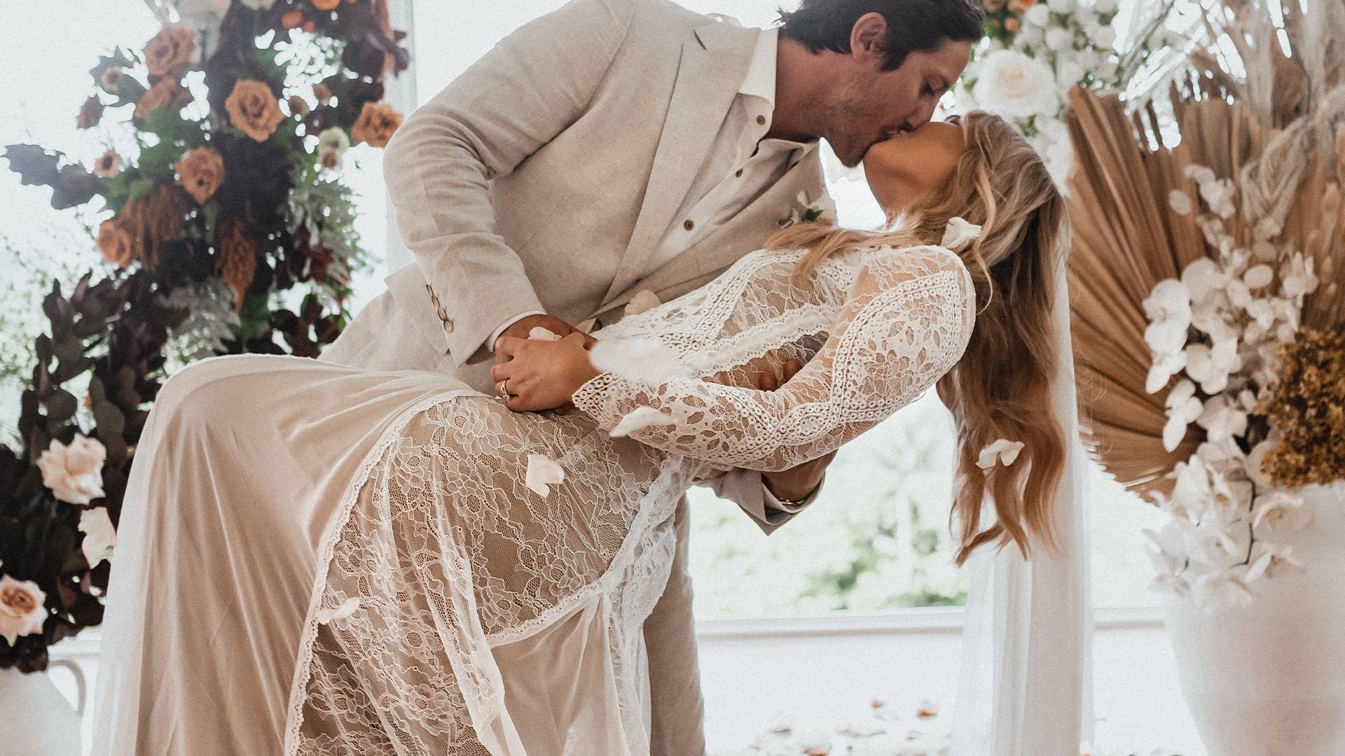 Grace Loves Lace bride wearing Inca wedding dress kissing her groom 