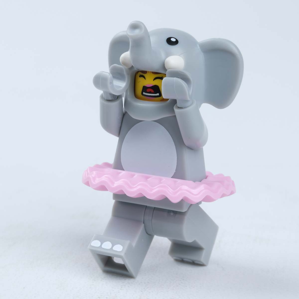 A lego person dresses up as an Elephant in a Tutu running away crying