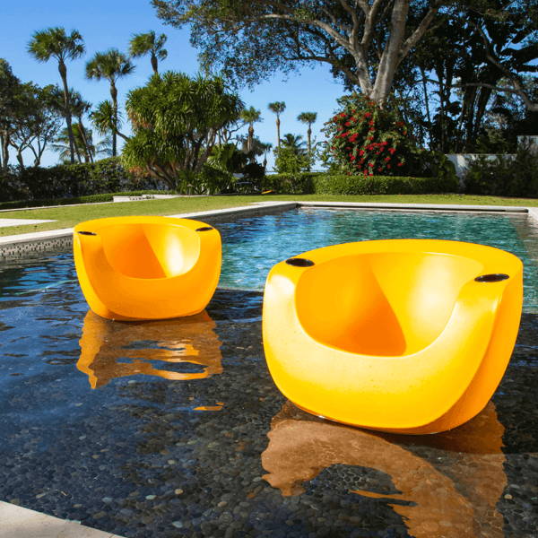 Bright yellow splash moon in-pool chairs with cupholders on pool tanning ledge.