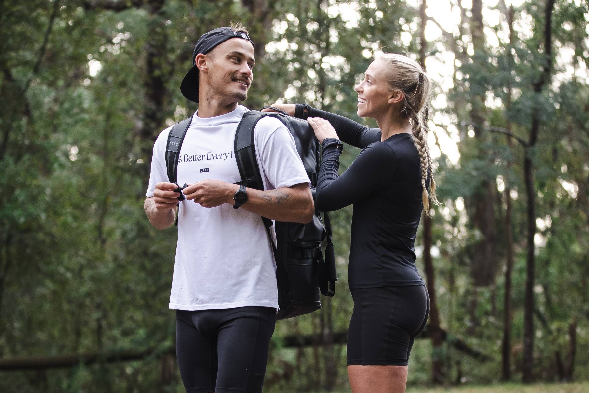 a male and female preparing for a trail run