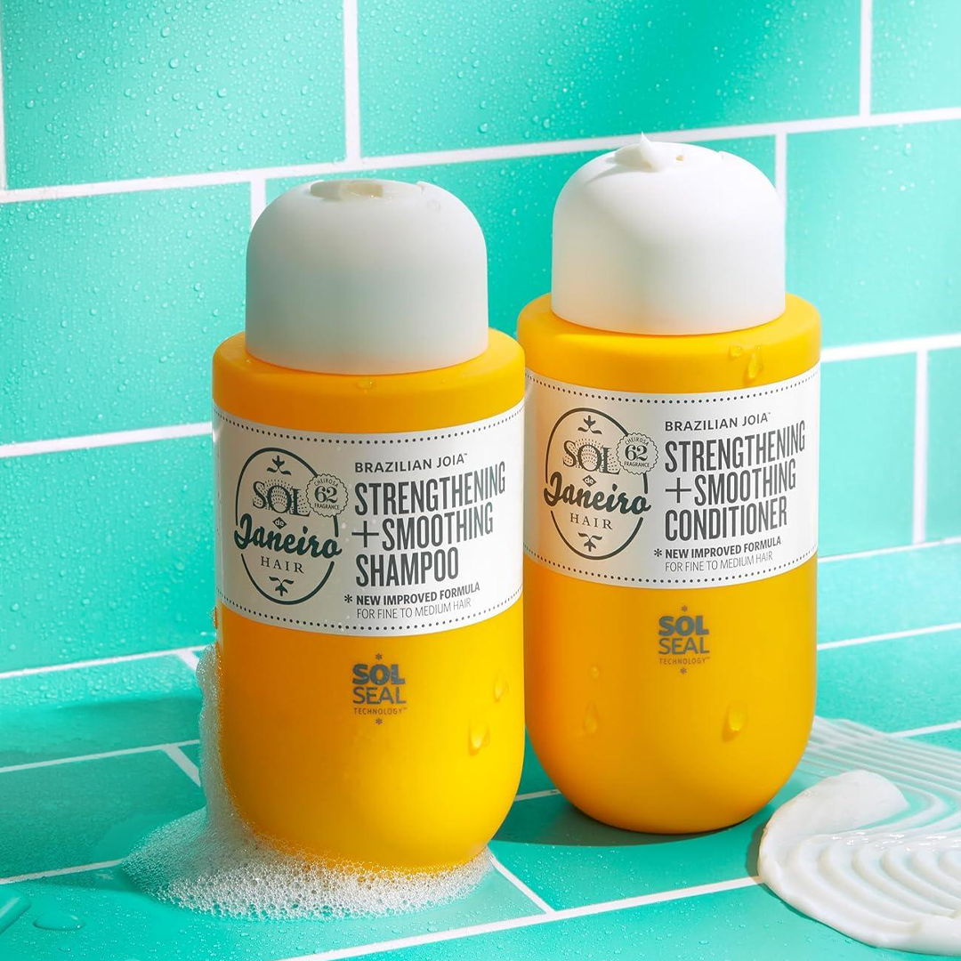 Two yellow shampoo and conditioner bottles on a turquoise tiled surface.