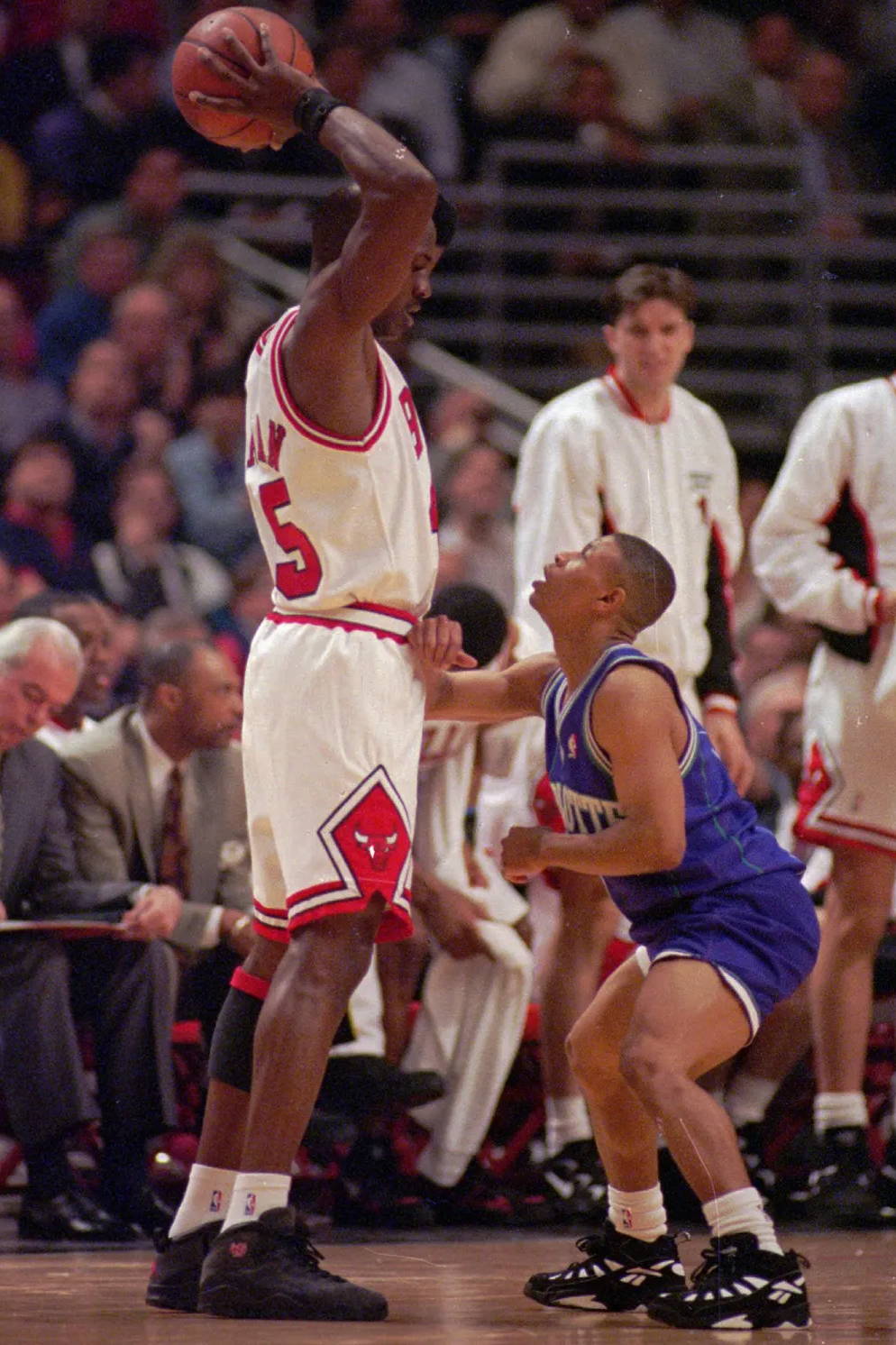 michael jordan in the aj10 towering over another basketball player