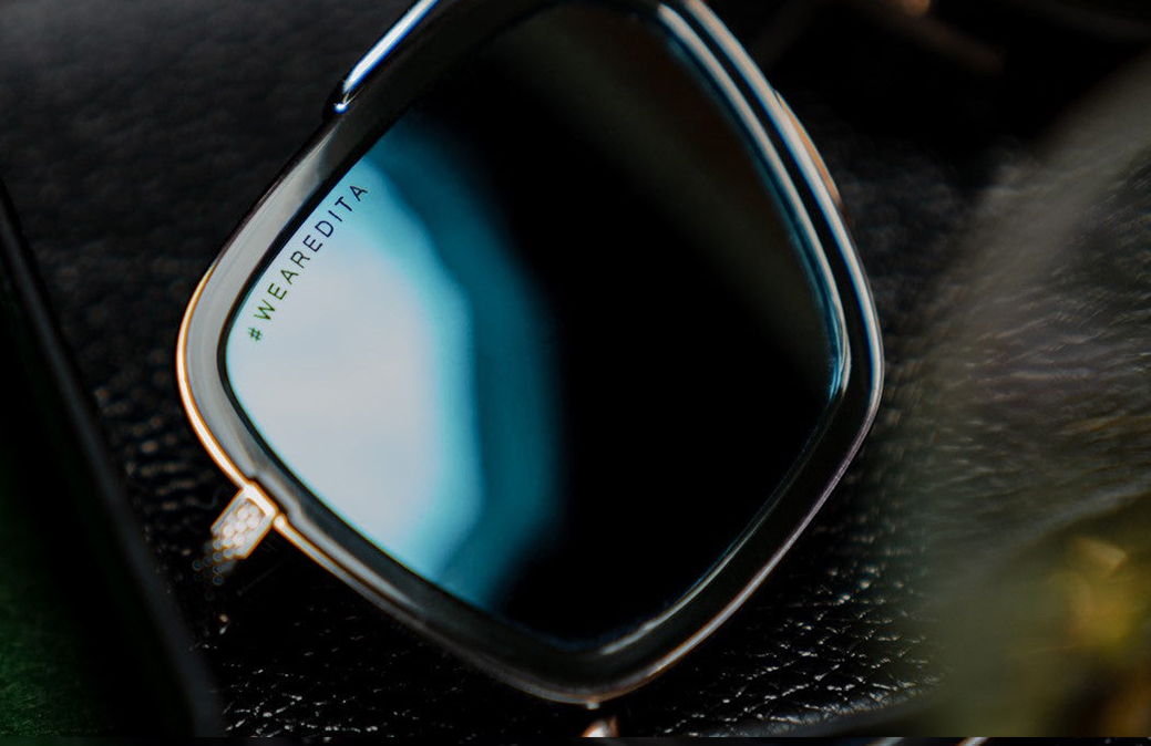 Close-up of stylish sunglasses resting on a textured surface.