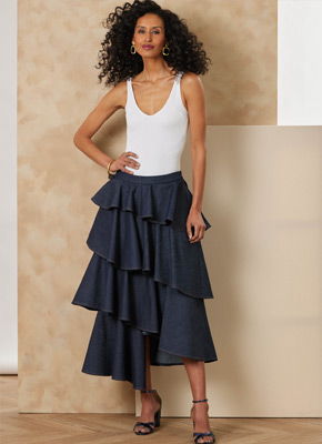 Model in a white top and layered denim skirt, posing against a neutral background.