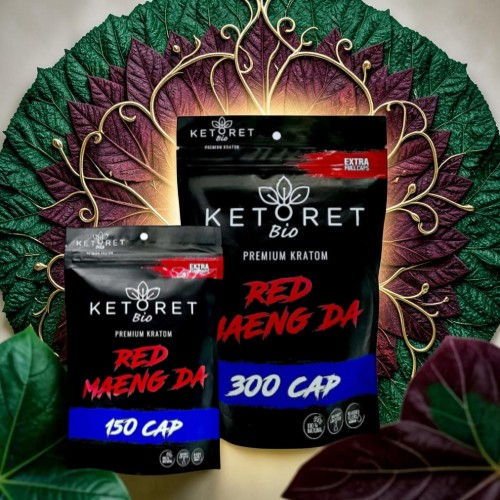 Two packages of Ketoret Bio Red Meng Da kratom, surrounded by decorative leaves.