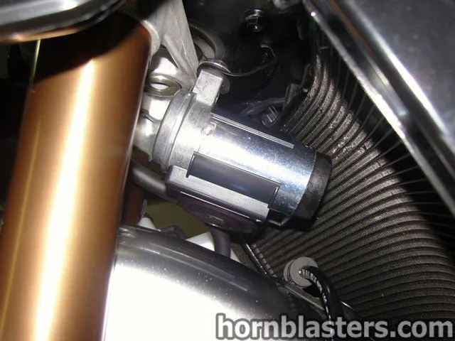 Front wheel and fork area of Del's Hayabusa showing compact electric horn placement and clearance photo 6