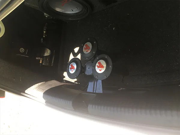 Angled trunk shot showing three-horn cluster and subwoofer enclosure in 2015 Volkswagen TDI Jetta gallery photo 5