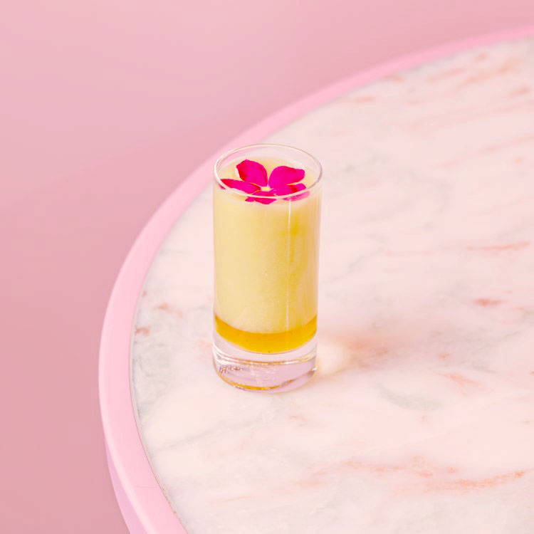 Ginger Lemon Health Shot with pink flower on top